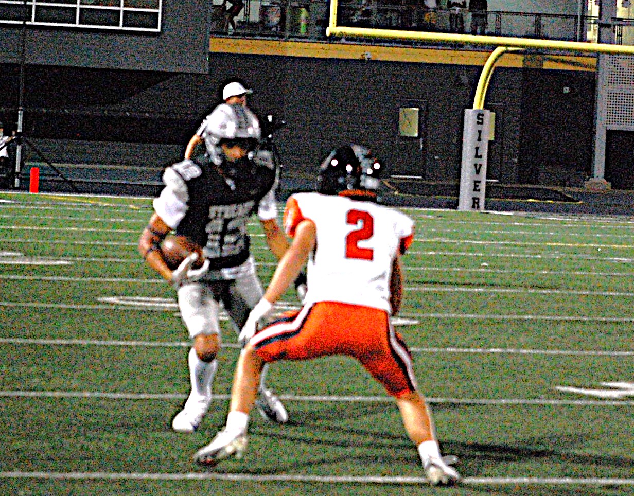 A Galesburg player attempts to elude a tackle from a United Township defender